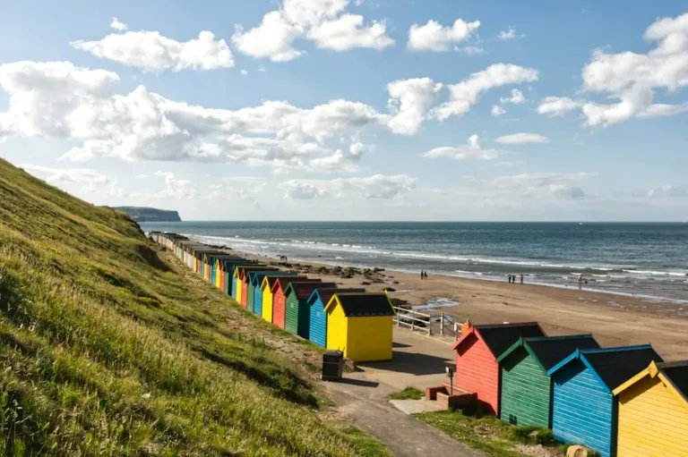 Colourful beach huts by the sea on a summer day