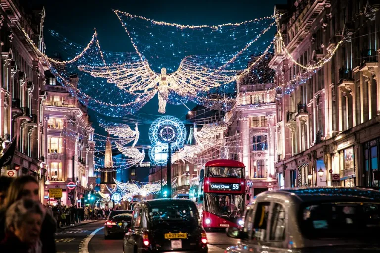 Christmas angel lights over a London street with a red bus and black cab