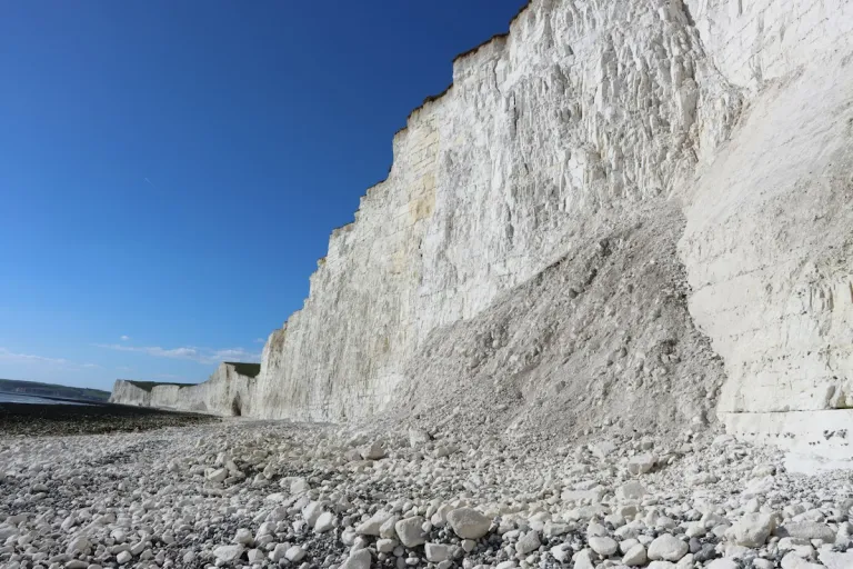 Rocky beach below white chalk cliffs at Birling Gap on the Seven Sisters coast, East Sussex