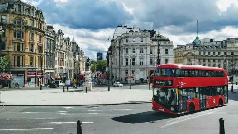Red bus passing Trafalgar Square in central London